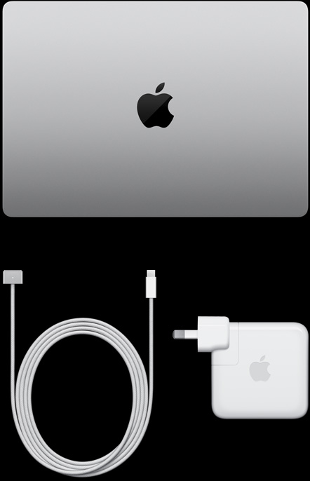 MacBook Pro, silver colour, top, closed, next to charging cable and adapter