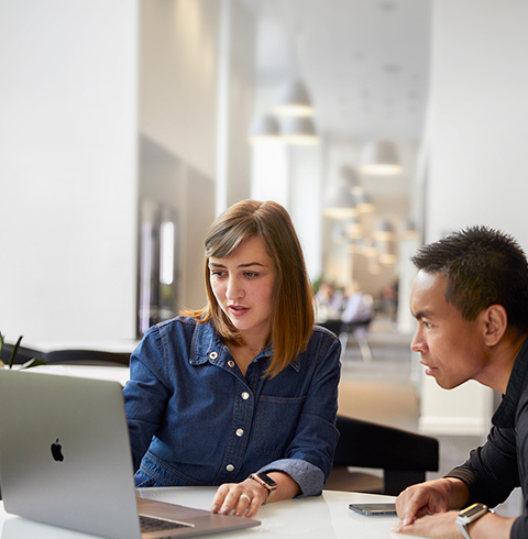 Apple Cork Support and Service team member talking with a co-worker.