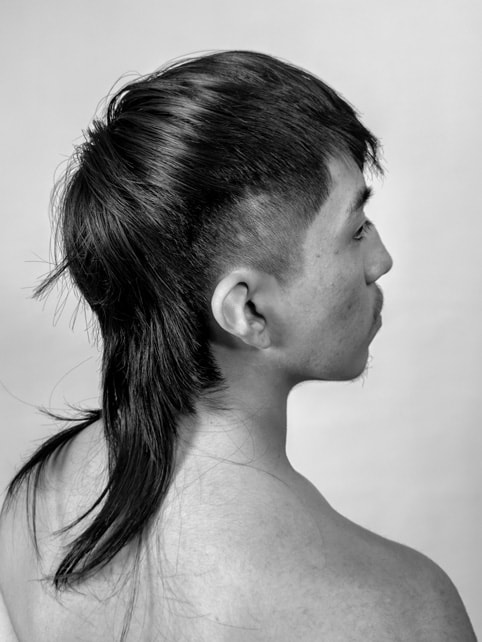 A black-and-white side-profile portrait shot on iPhone 15 Pro Max. 