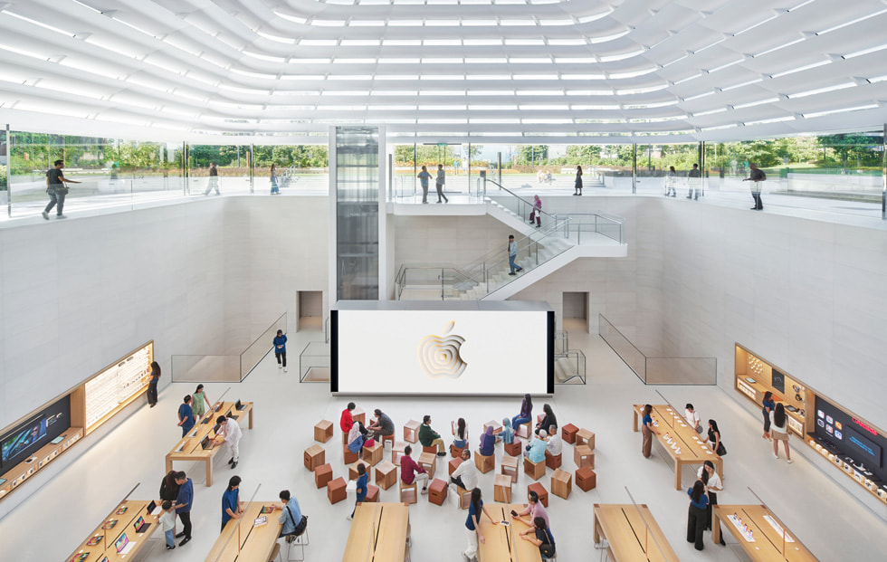 A zoomed-out interior shot shows all of the store’s levels, including its sculptural quartz and glass staircase.