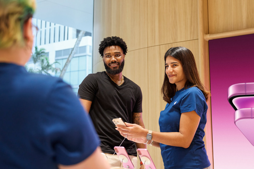 A team member assists a customer with iPhone 16 Pro. 