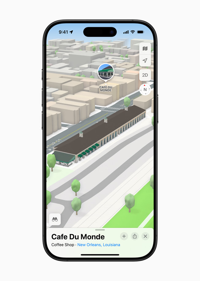 On iPhone 16 Pro, a 3D landmark for Cafe Du Monde in New Orleans is shown in Apple Maps.