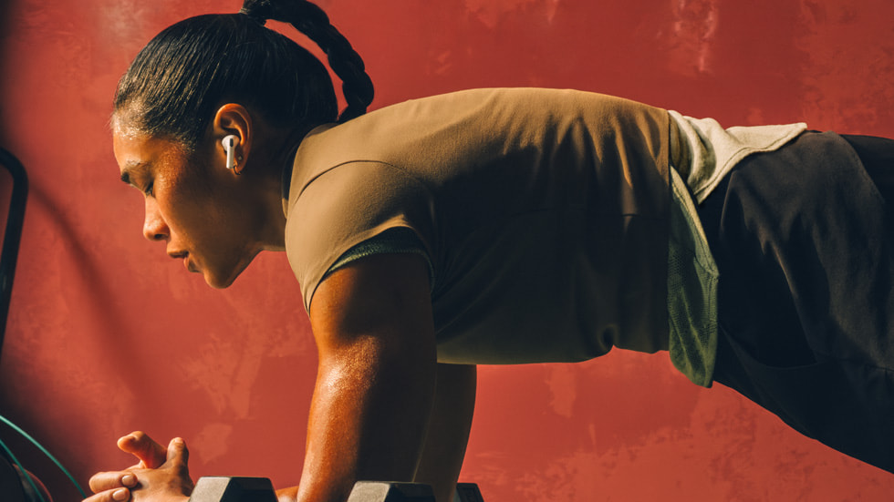 An image of a user wearing AirPods Pro 3 during a workout.