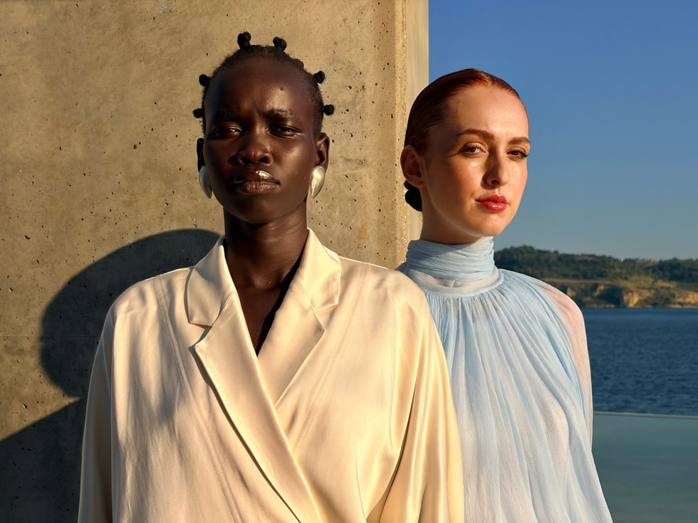 An editorial-style photo of a person wearing all white against an abstract black-and-white backdrop showing Photographic Styles and taken on iPhone Air.