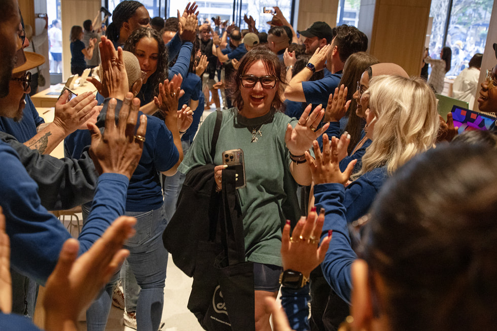 Team members greet the first customers to arrive at Apple Downtown Detroit.