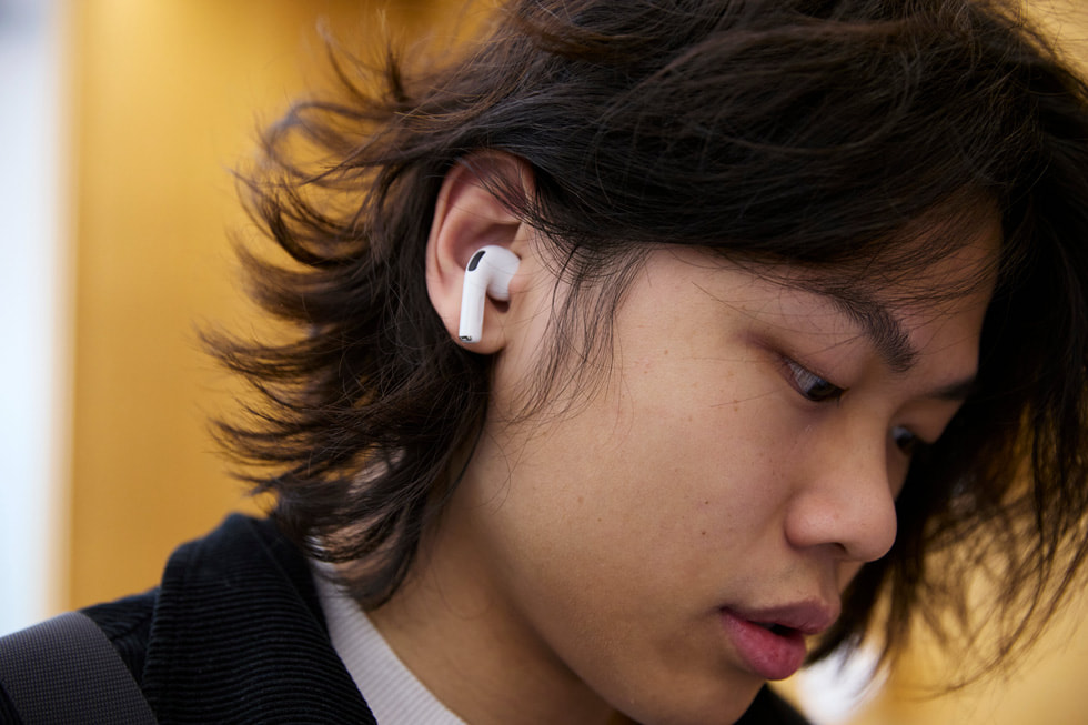 A customer tests out AirPods Pro 3 at the Apple Sydney store in Australia.