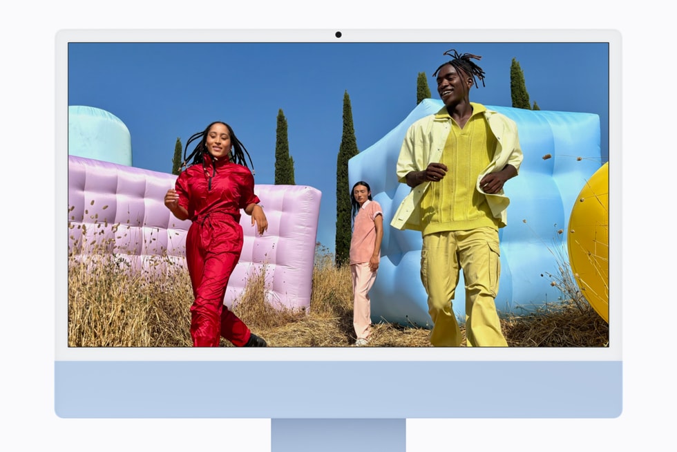iMac with M6 in blue displays a still of three individuals outside.