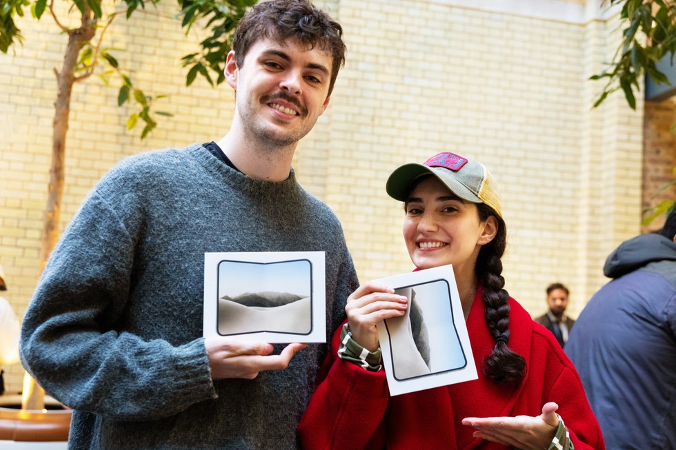 At Apple Covent Garden, two customers show off their new iPhone Duo purchases.