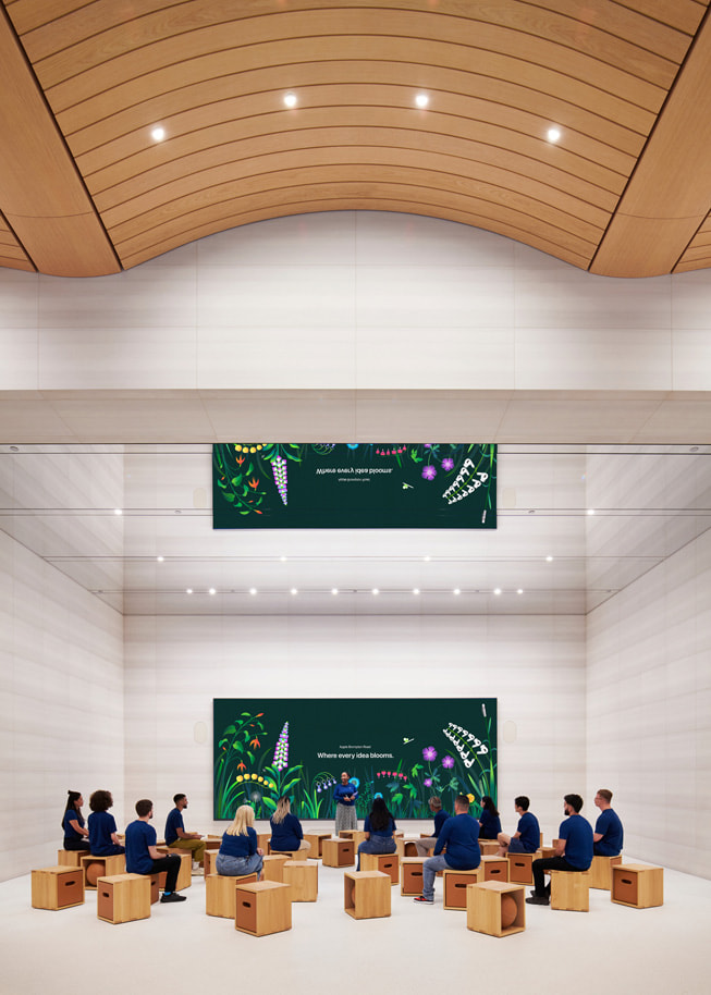 People sit in the Forum at Apple Brompton Road.