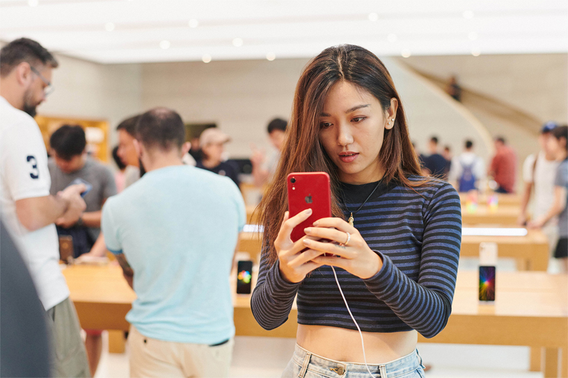 Customer looks at iPhone XR.