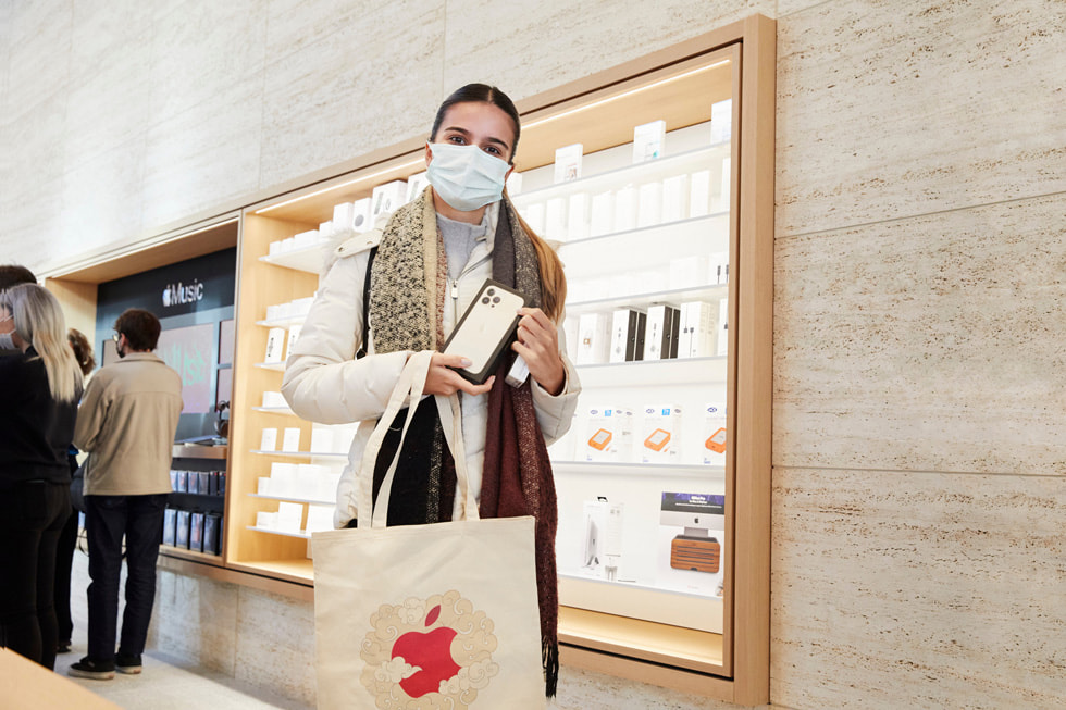 A customer holds their new iPhone 13 Pro.