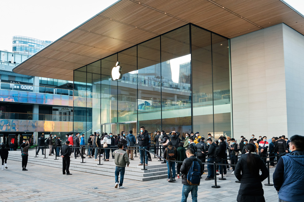Customers outside Apple Sanlitun wait in line to shop the new iPhone 12 Pro Max and iPhone 12 mini.
