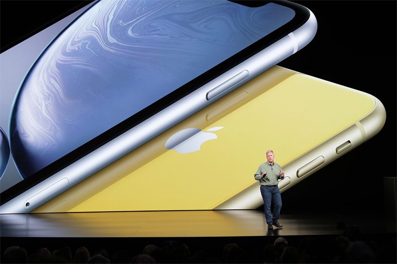 Phil Schiller in front of iPhone Xr image on stage.