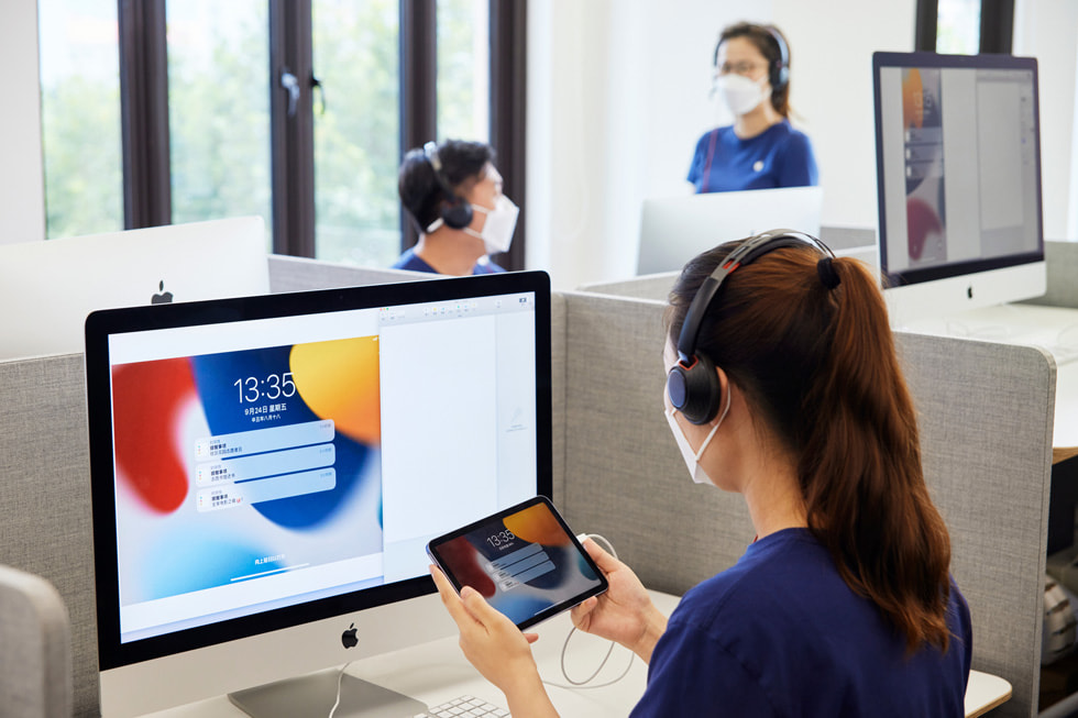 An Apple online team member at the call center in Shanghai advises a customer on the new iPad mini.