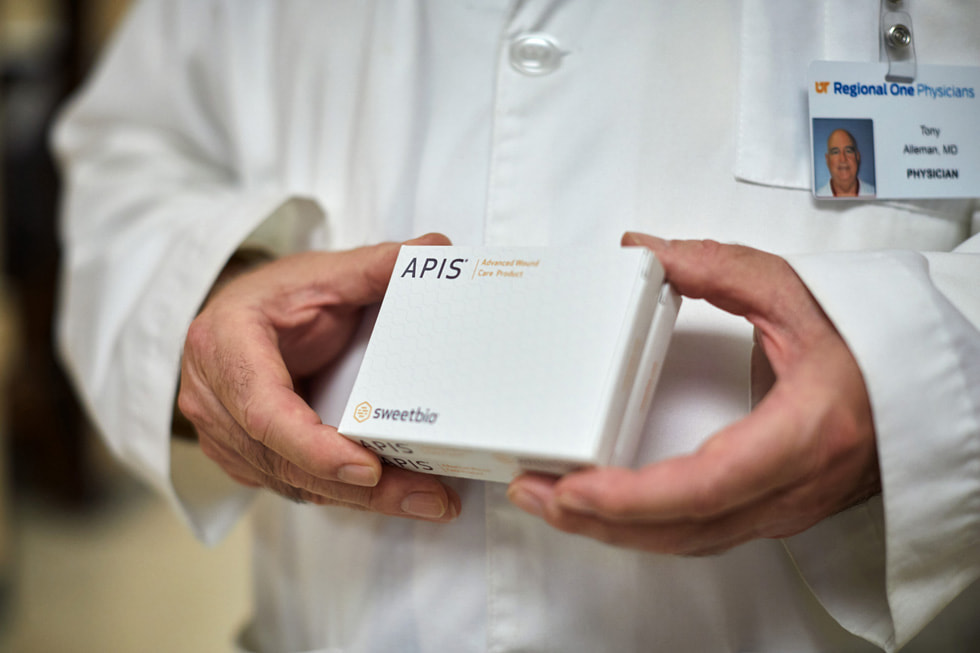 Dr. Tony Alleman of Regional One Health’s Wound Care Center holding APIS boxes.