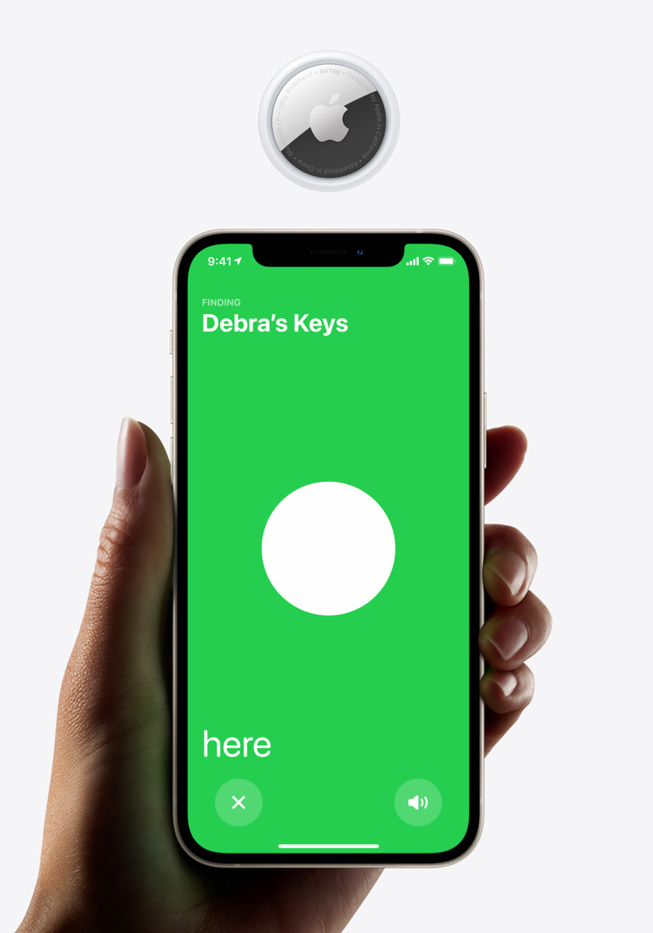 iPhone 12 displaying AirTag finding screen, along with AirTag device.