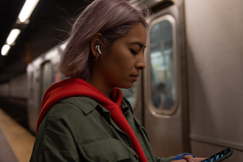 An AirPods Pro user waiting for a train.