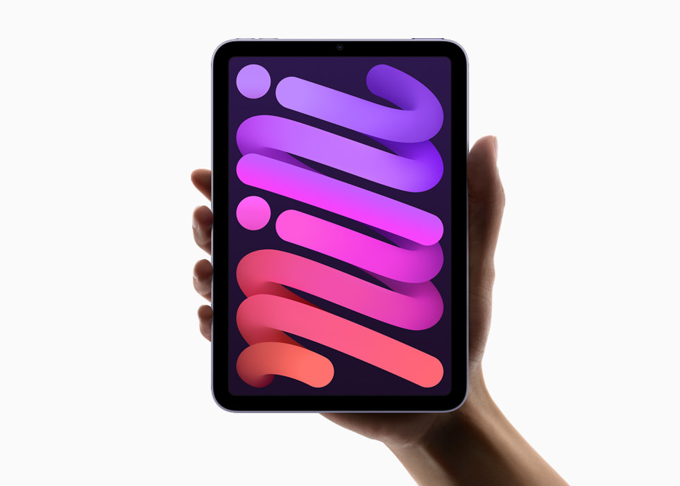 A hand holding iPad mini vertically.