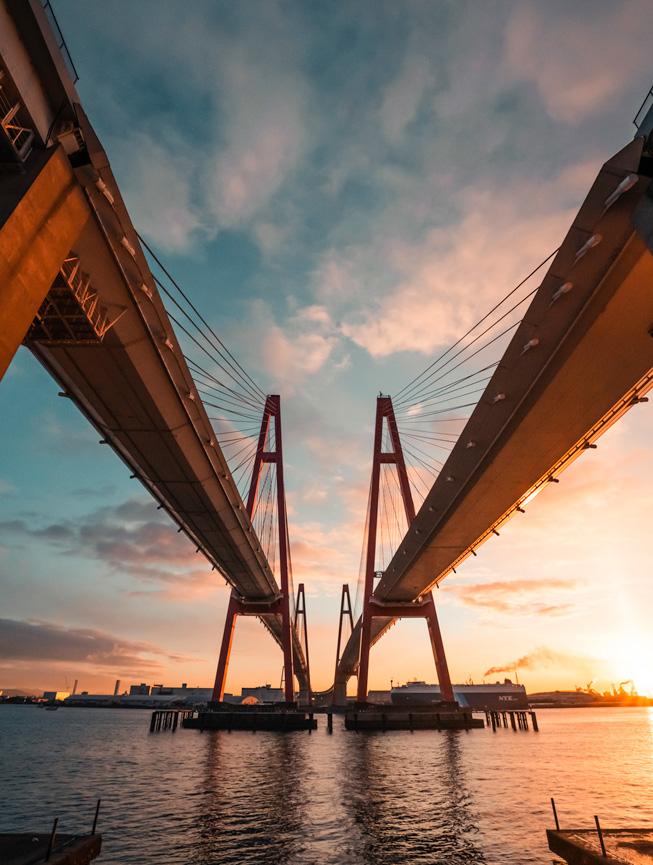 The spires of twin red bridges reach skyward.