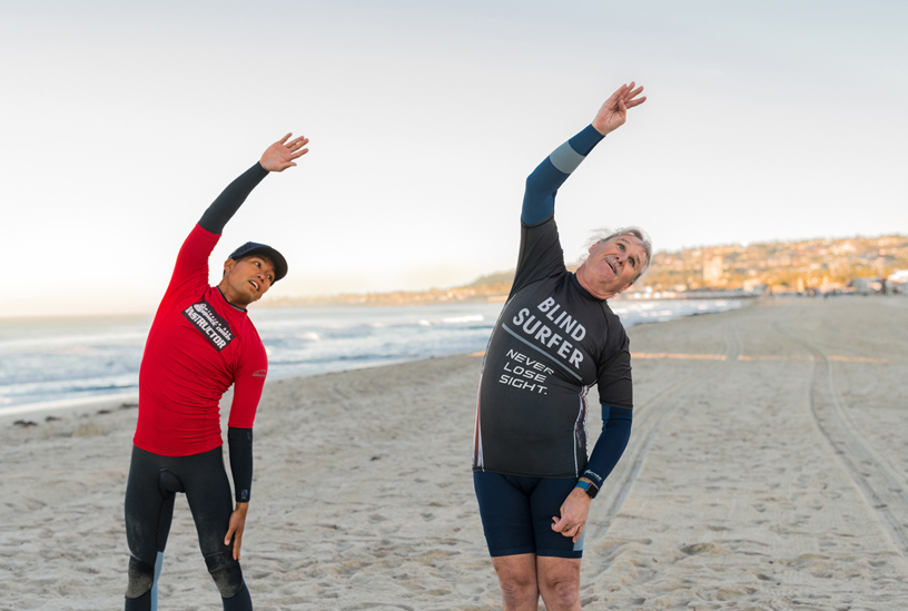 Leason and Lau have a yoga session on the beach.