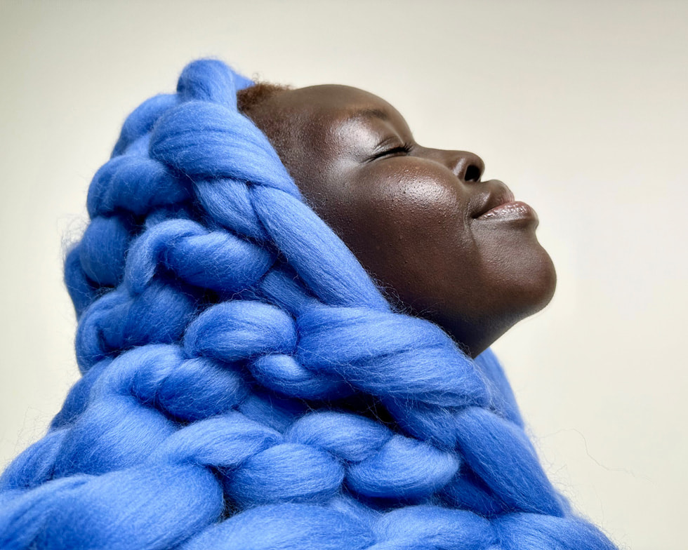 A person with blue hair is shown from the side.
