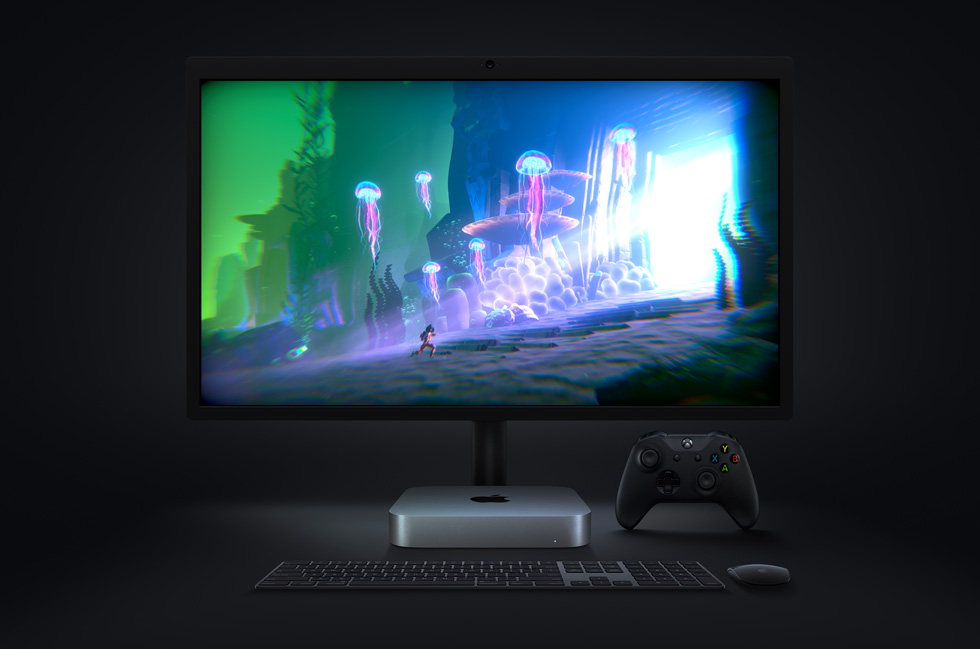 The video game “Little Orpheus”, running on Mac mini, is displayed on a monitor, with a wireless keyboard and mouse and an Xbox controller nearby.