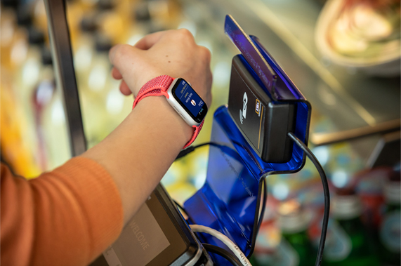 A student scanning his Apple Watch to pay for a meal on campus.