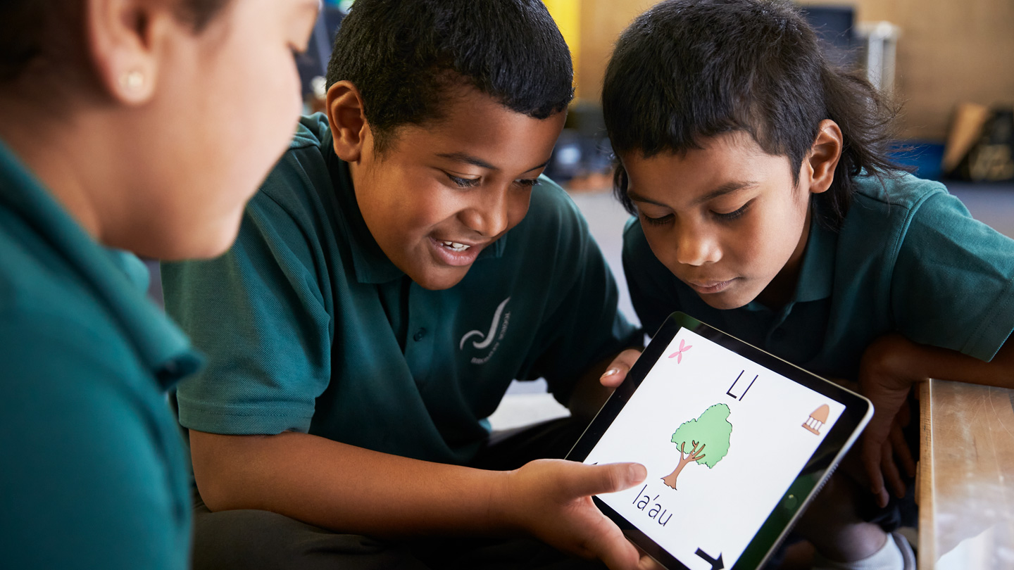 Bromley School students Leonie Bradbrook, Talia Uasi, and Siosaia Uasi using iPad.