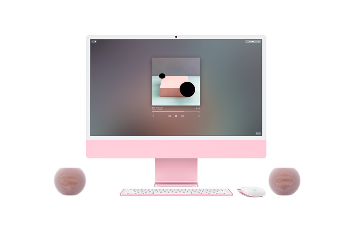 Pink iMac, front exterior, Apple Music playing on screen, colour-matched Magic Keyboard and Magic Mouse, flanked by two pink HomePod mini speakers in a stereo pair setup