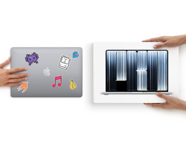 A hand slides a MacBook with stickers on the cover toward two hands holding a new MacBook in the box